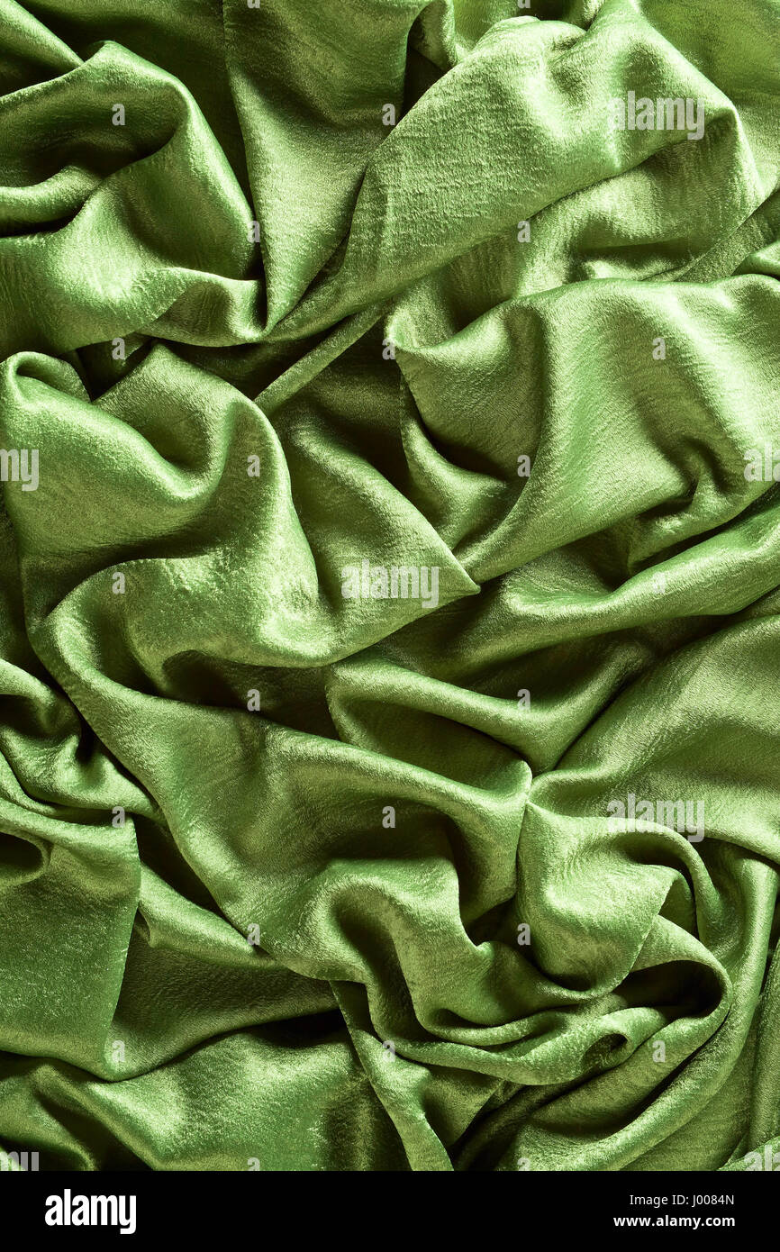 Smooth elegant green satin or silk .Cloth texture can use as background ...