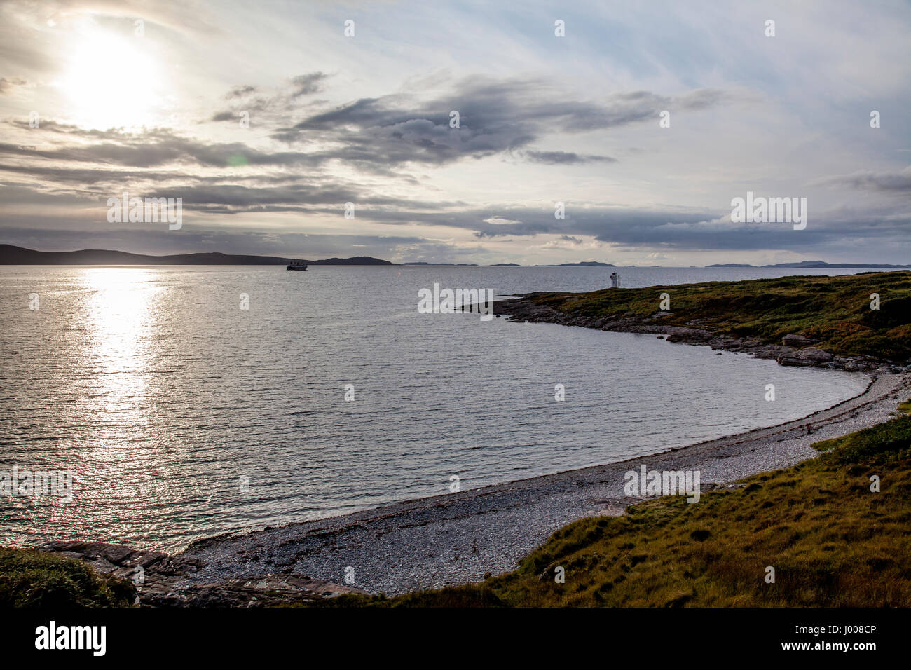 Rhue Lighthouse on Loch Broom Wester Ross, north of Ullapool, with CalMac Ferry for Stornoway Stock Photo