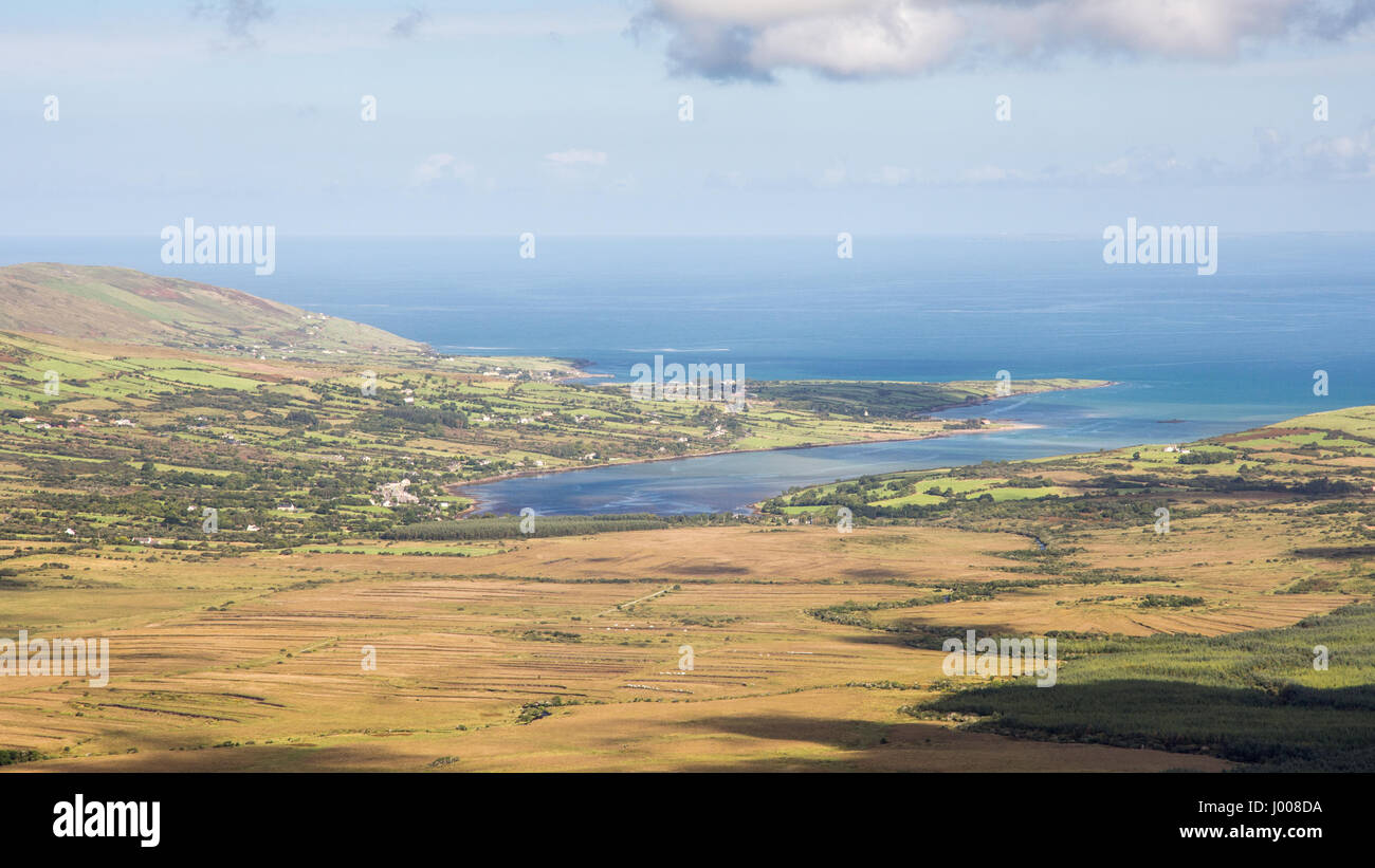 Rivers flowing from the mountains of Ireland's Dingle Peninsula flow through the Owenmore Valley into the Cloghane Estuary and Tralee Bay, as viewed f Stock Photo