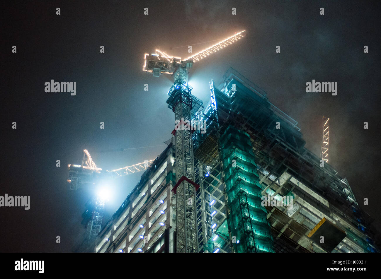 London, England, UK - December 16, 2009: Winter mist drifts across the Heron Tower skyscraper under construction in the City of London. Stock Photo