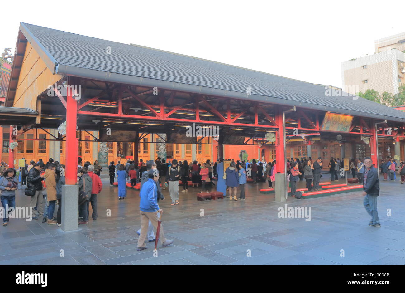 People visit Hsing Tian Temple in Taipei Taiwan. Hsing Tian Temple is devoted to Guan Yu the patron god of businessmen. Stock Photo