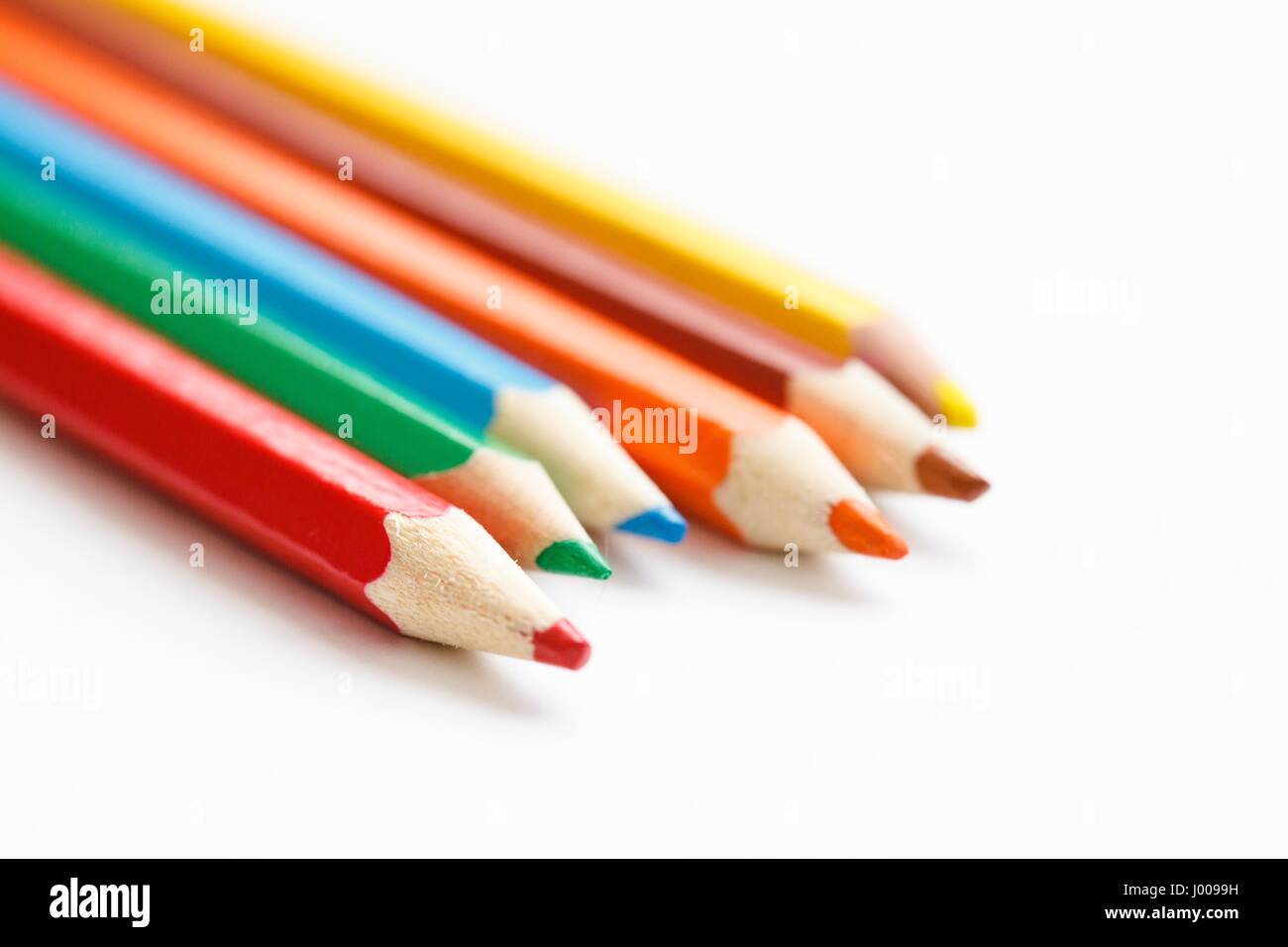 group of multicolored pencils lying on a white table Stock Photo - Alamy