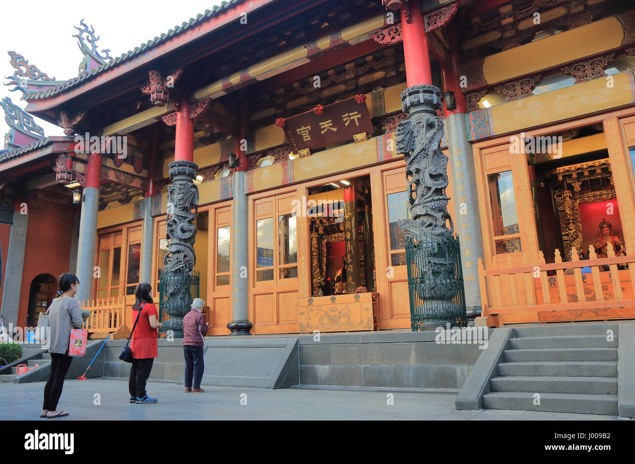 People visit Hsing Tian Temple in Taipei Taiwan. Hsing Tian Temple is devoted to Guan Yu the patron god of businessmen. Stock Photo