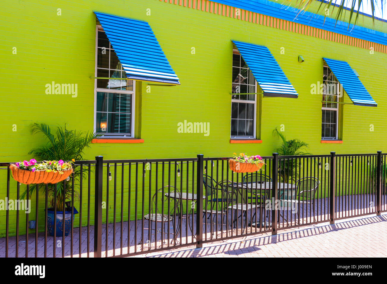 Bright Lime Green Walled Three Window Building With Blue And Orange Accents Stock Photo Alamy