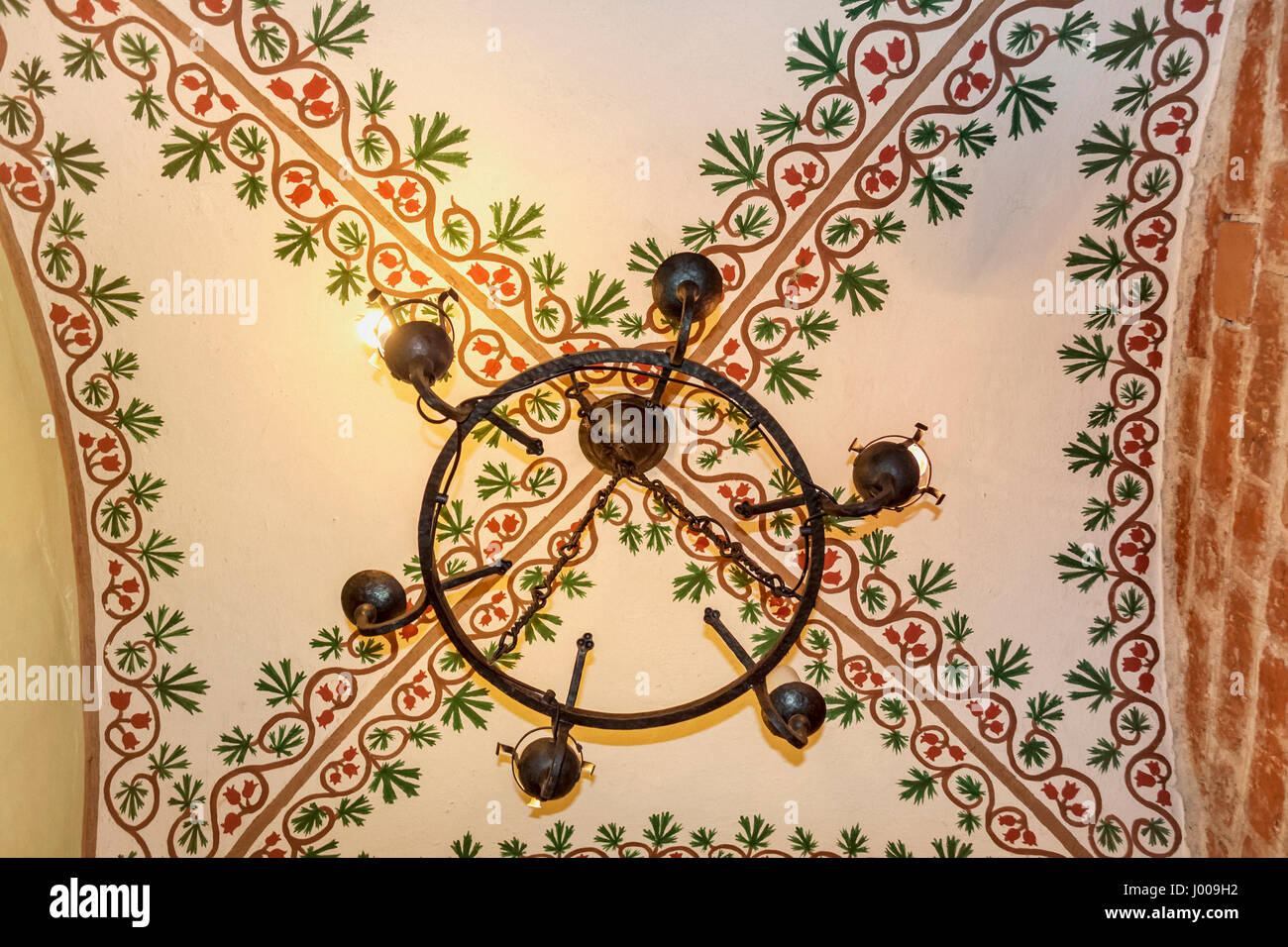 Decorated ceiling with steel chandelier in Teutonic castle in Gniew, Poland Stock Photo