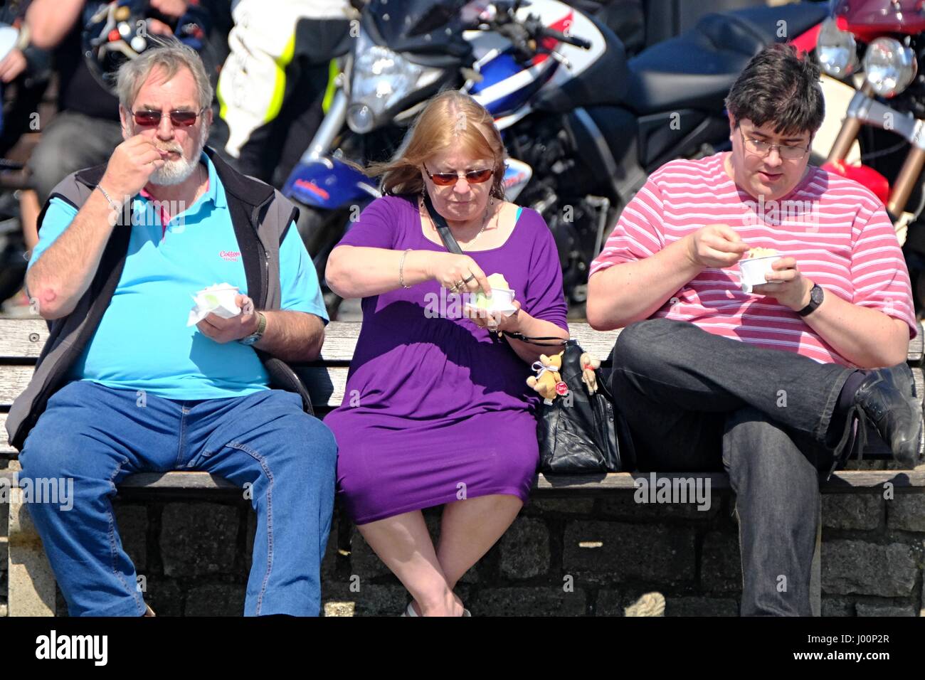 West Bay, Dorset, UK. 8th Apr, 2017. These three visitors cool off with an ice cream as crowds flock to West Bay in Dorset to enjoy what looks like the warmest day of the year. Credit: Tom Corban/Alamy Live News Stock Photo