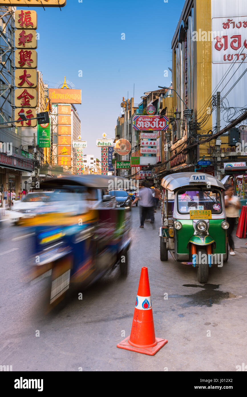 Bangkok, Thailand - April 24, 2016: Tuk-tuk taxi parked near street market in Chinatown on April 24, 2016 in Bangkok, Thailand. Stock Photo