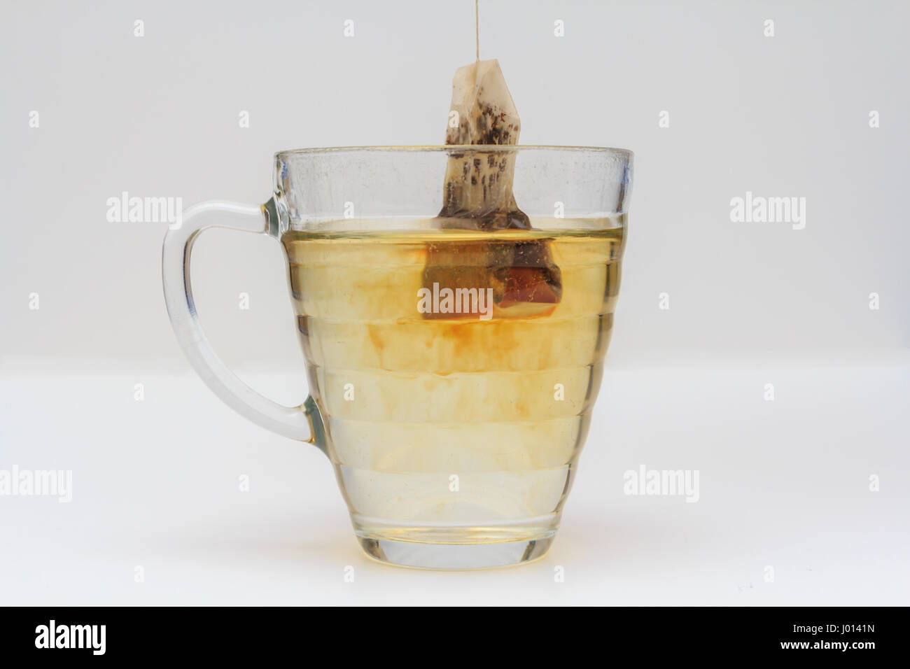 glass mug of tea with tea bag on white background Stock Photo