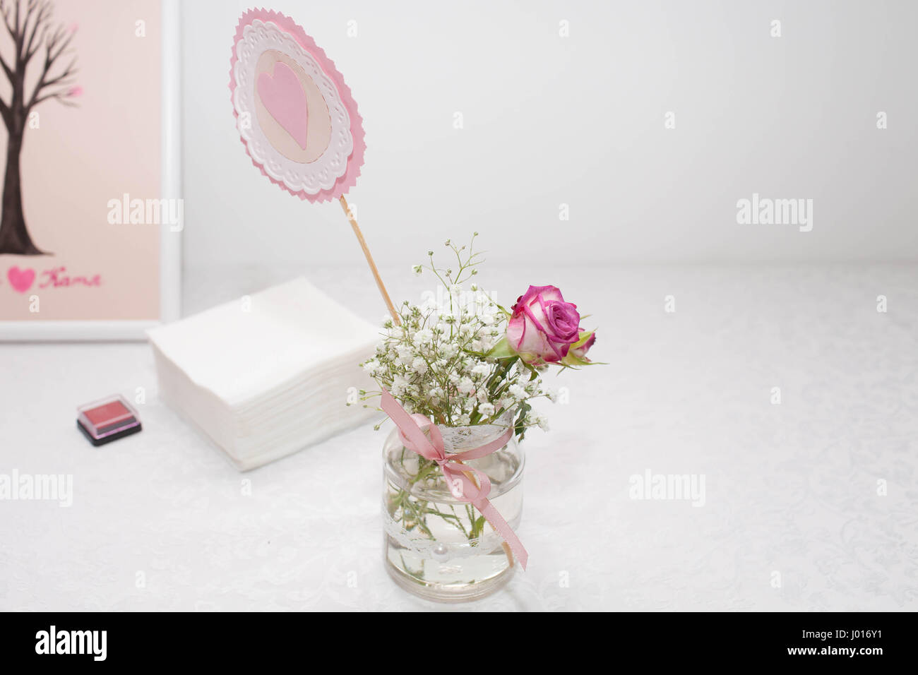 Jar with rose and baby's breath. Wedding decorations. Close-up Stock Photo