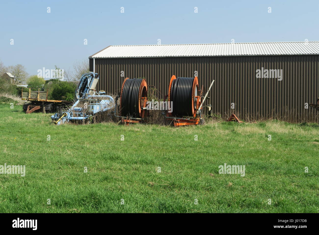 Farm equipment outside a Cambridgeshire barn Stock Photo