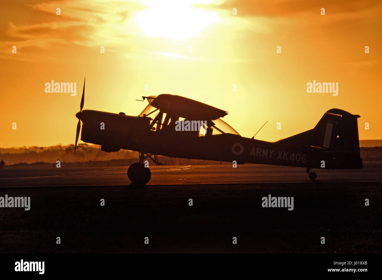 A silhouetted Royal Australian Army Auster observation aircraft at sunset. Stock Photo