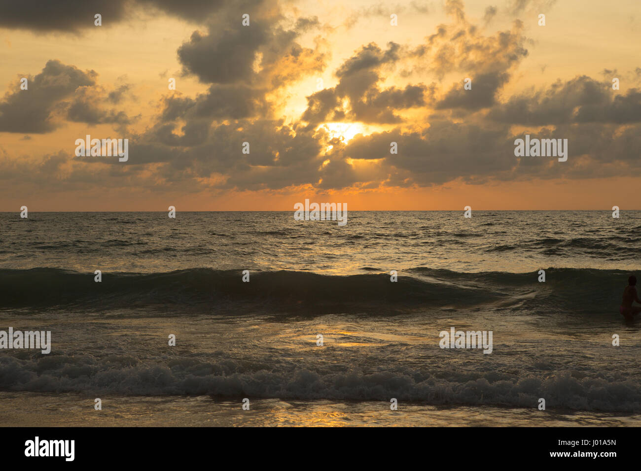 a beautiful sunset in the sea on the beach Stock Photo - Alamy
