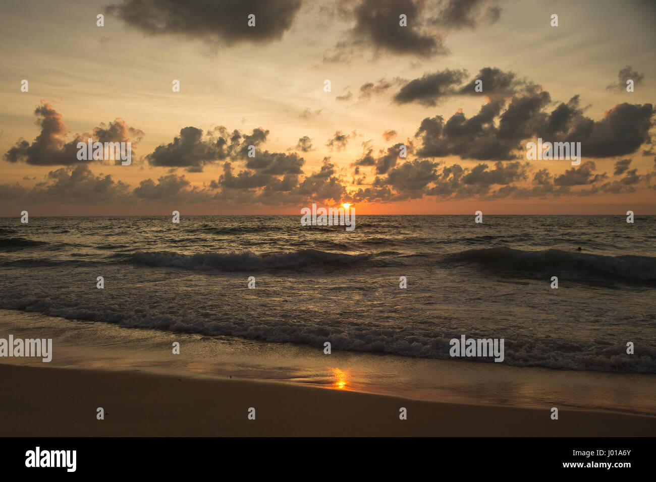 a beautiful sunset in the sea on the beach Stock Photo - Alamy