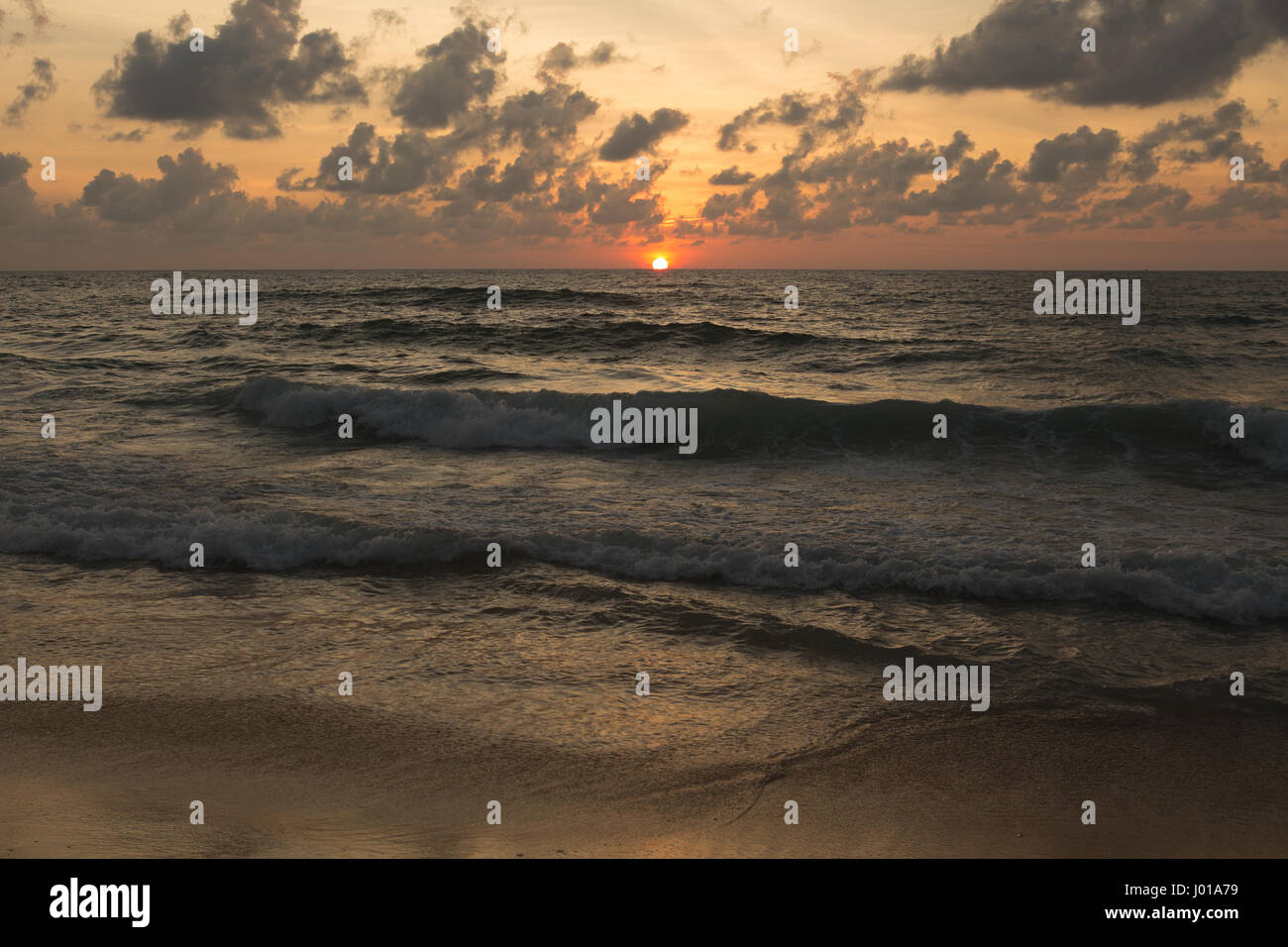 a beautiful sunset in the sea on the beach Stock Photo - Alamy