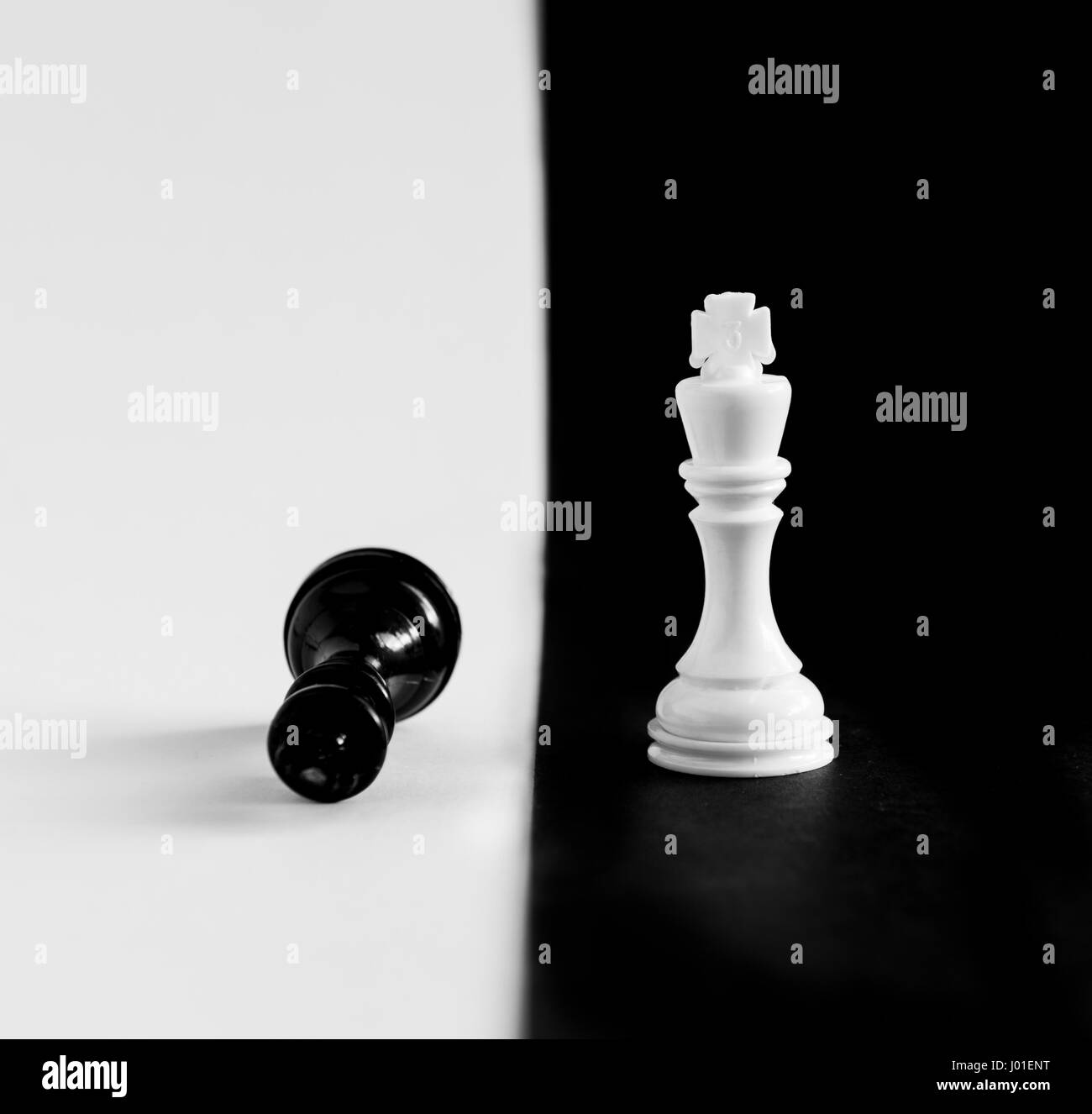 King and Queen chess game pieces on a black and white board Stock Photo