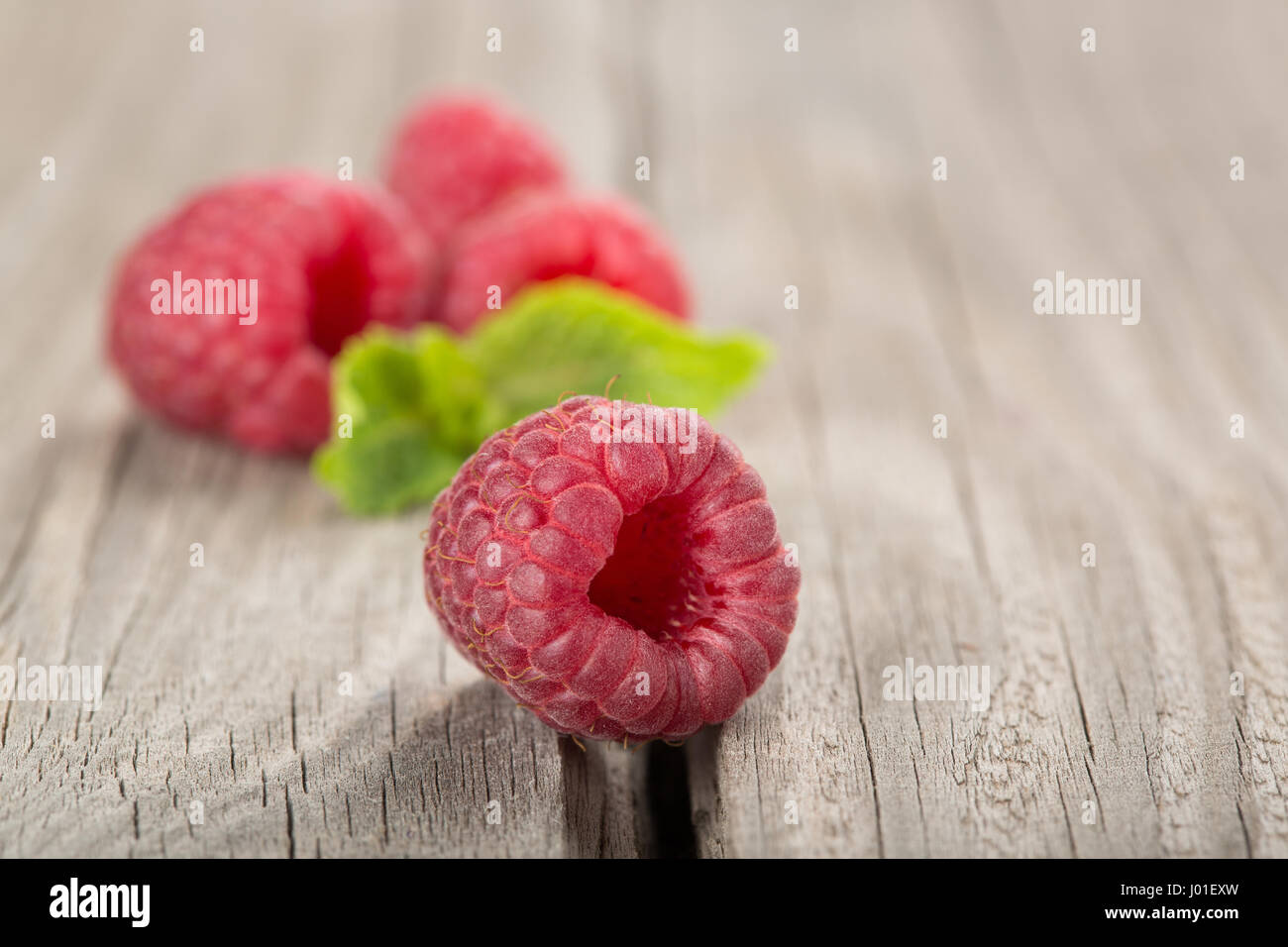 One Raspberry On A Table Raspberry on the old a wooden table Stock Photo - Alamy