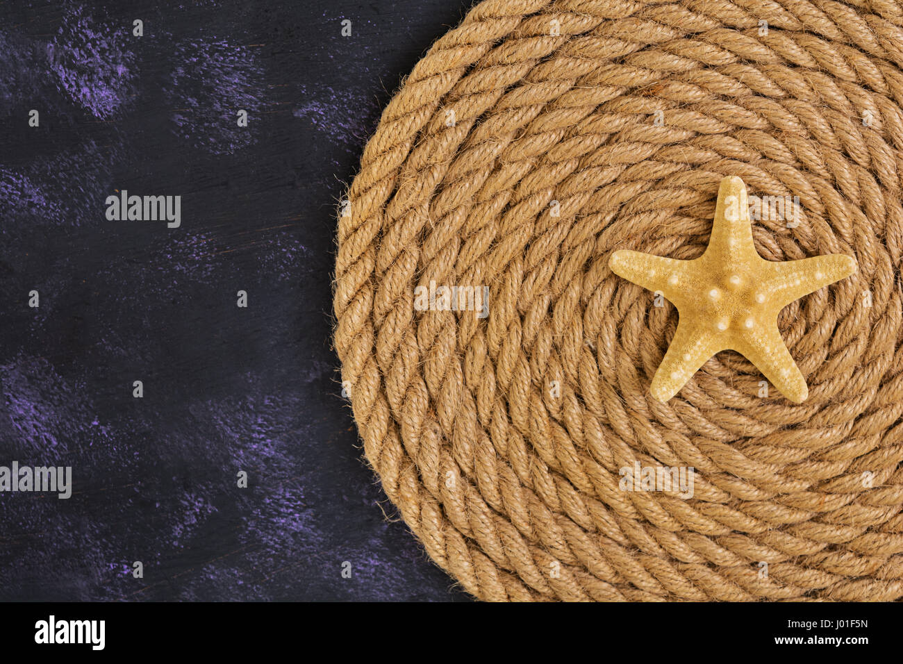 Rope and starfish on dark background. Top view Stock Photo - Alamy