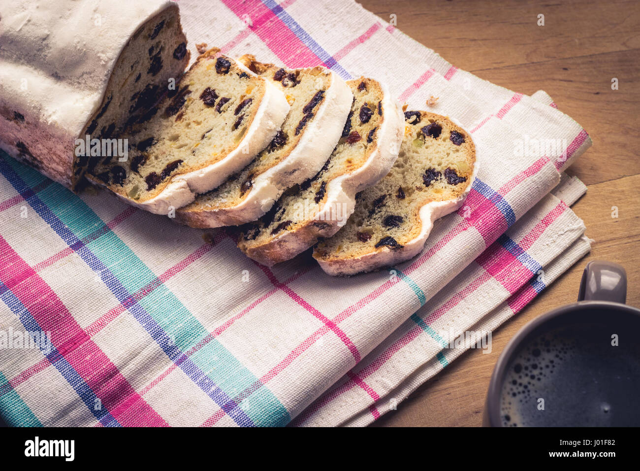 Stollen, traditional German Christmas yeast cake with raisins served