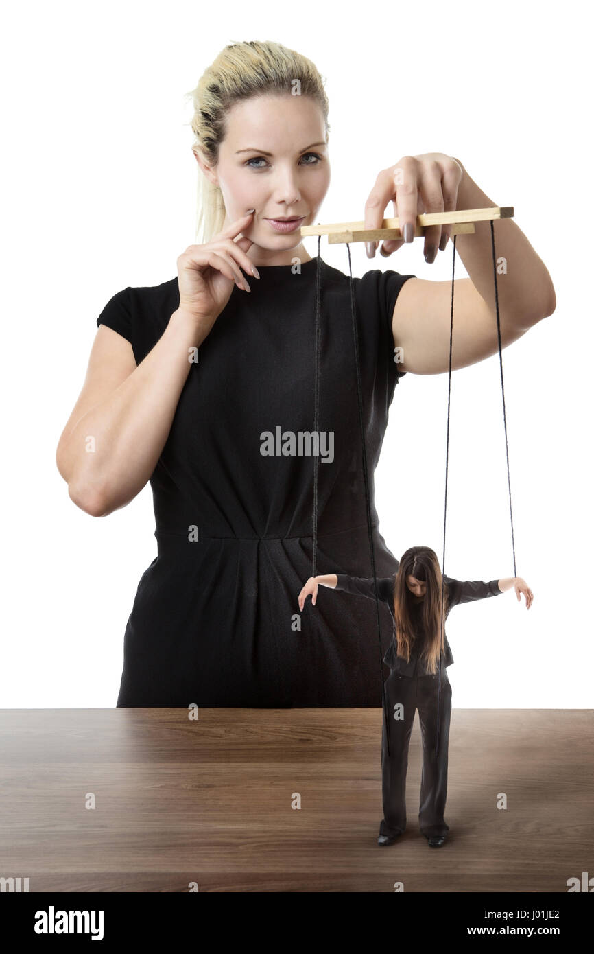 business woman puppet master pulling on strings of a doll Stock Photo