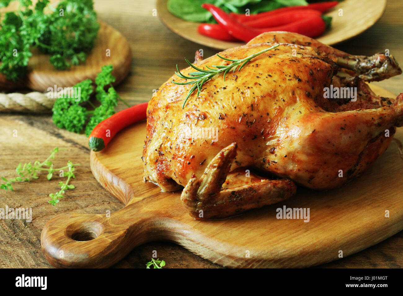 Whole roasted chicken on cutting board Stock Photo - Alamy