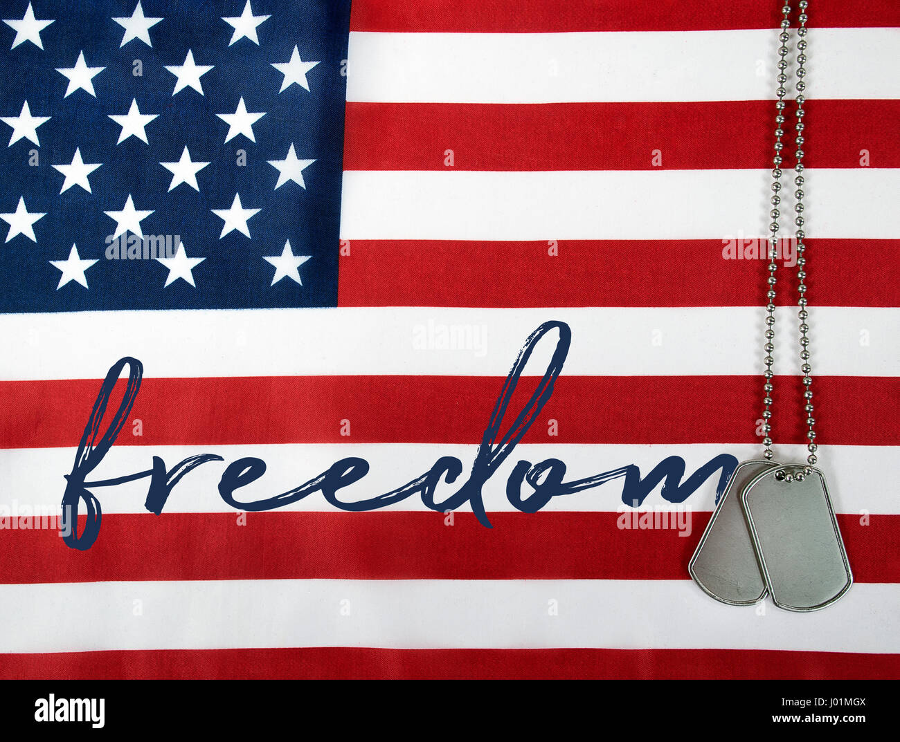 word freedom and military dog tags on American flag Stock Photo