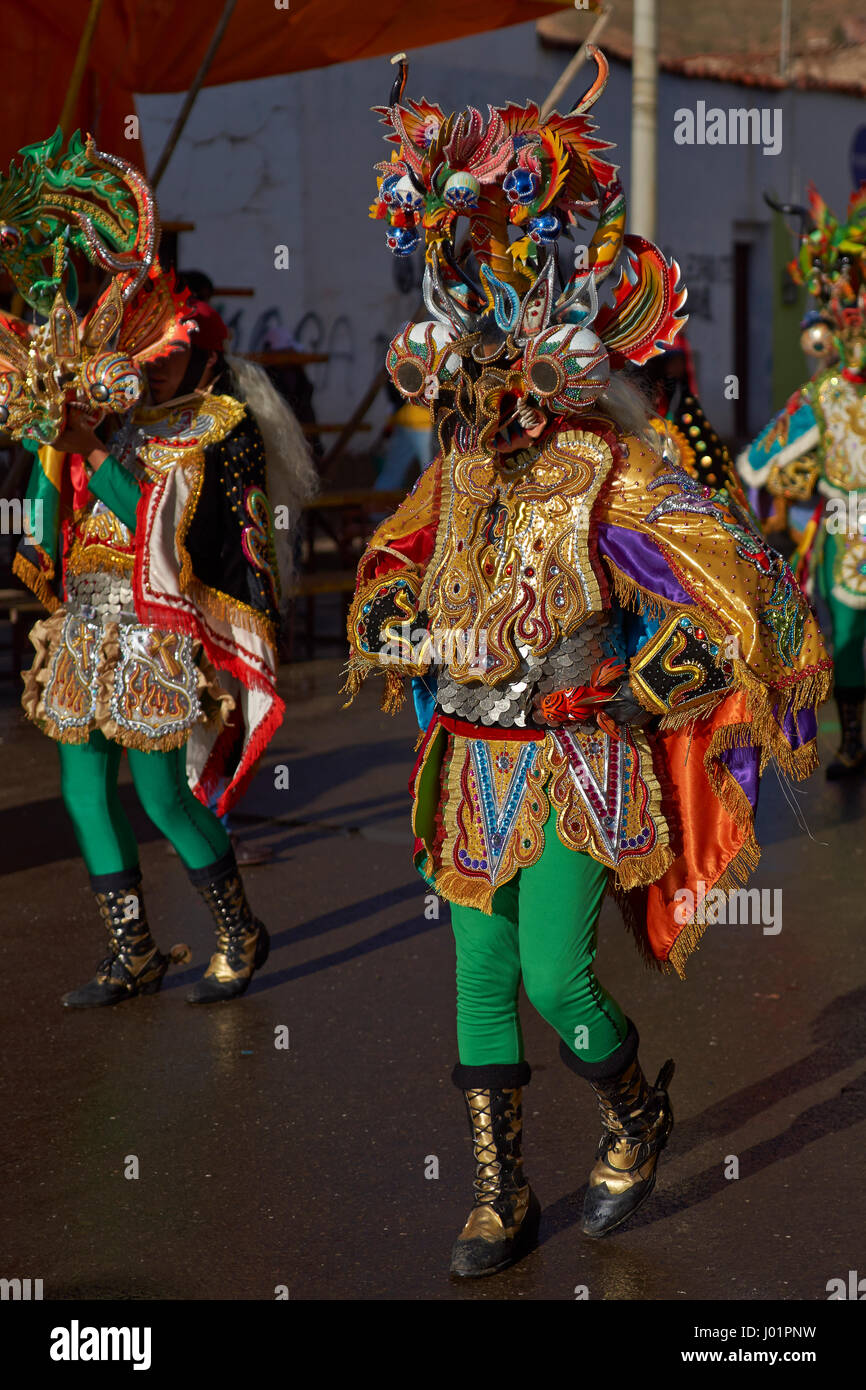 Masked Diablada dancers in ornate costumes parade through the mining city of Oruro on the Altiplano of Bolivia during the annual carnival. Stock Photo