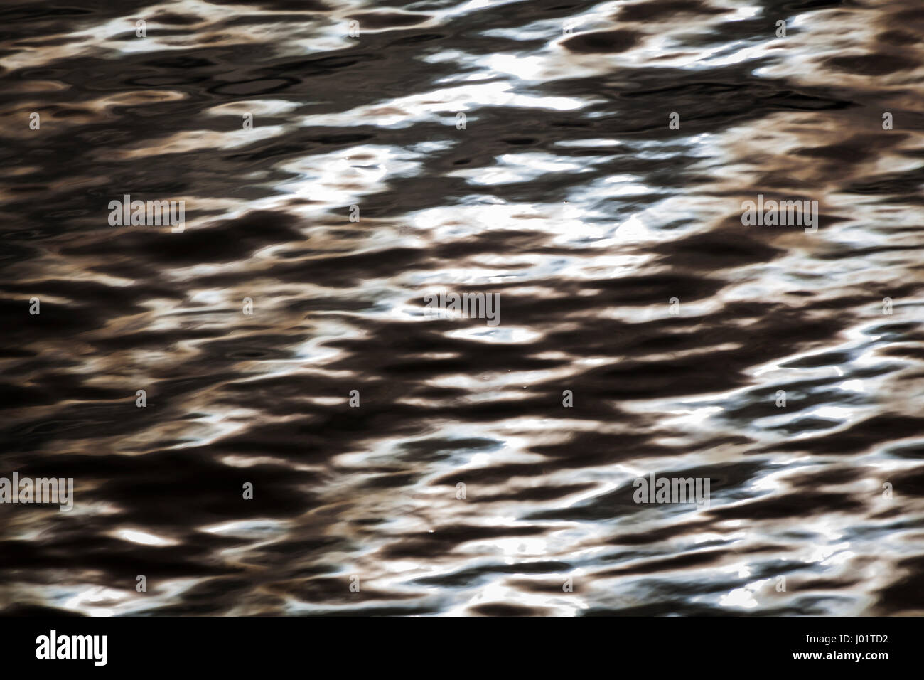 Rippling waters are smoothed by a slow shutter speed and colors enhanced in software to create an abstract picture or background for graphic design. Stock Photo