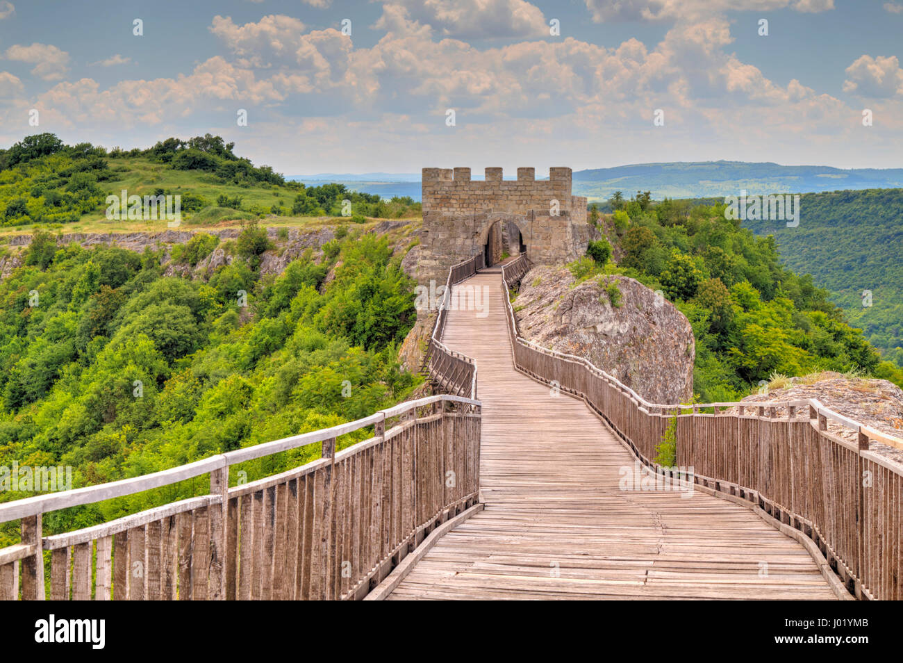 Stone walls and gate with wooden bridge of medieval fortress Stock ...