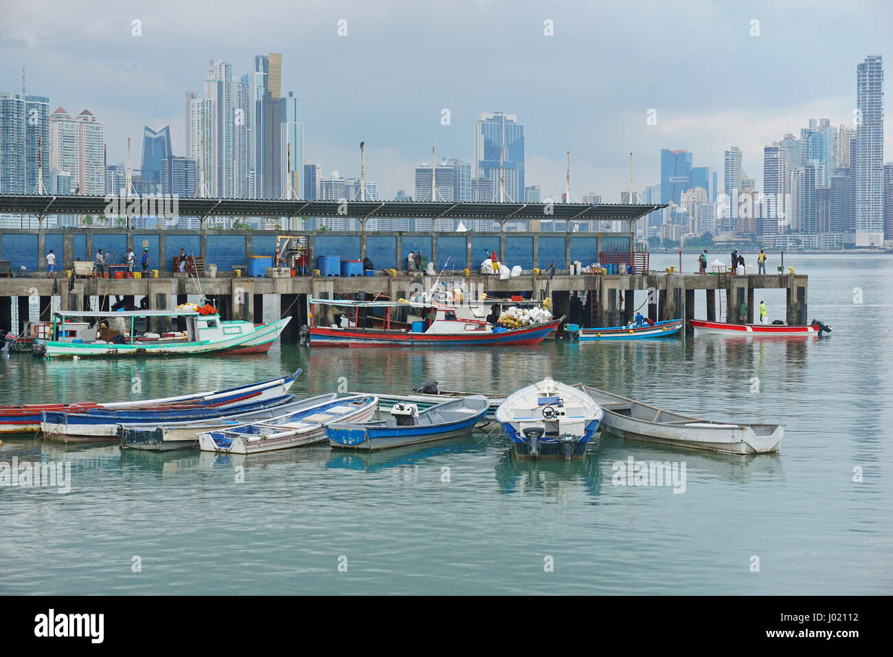 Wharf and boats of the fishing harbor of Panama city with skyscrapers in background, Pacific coast, Panama, Central America Stock Photo