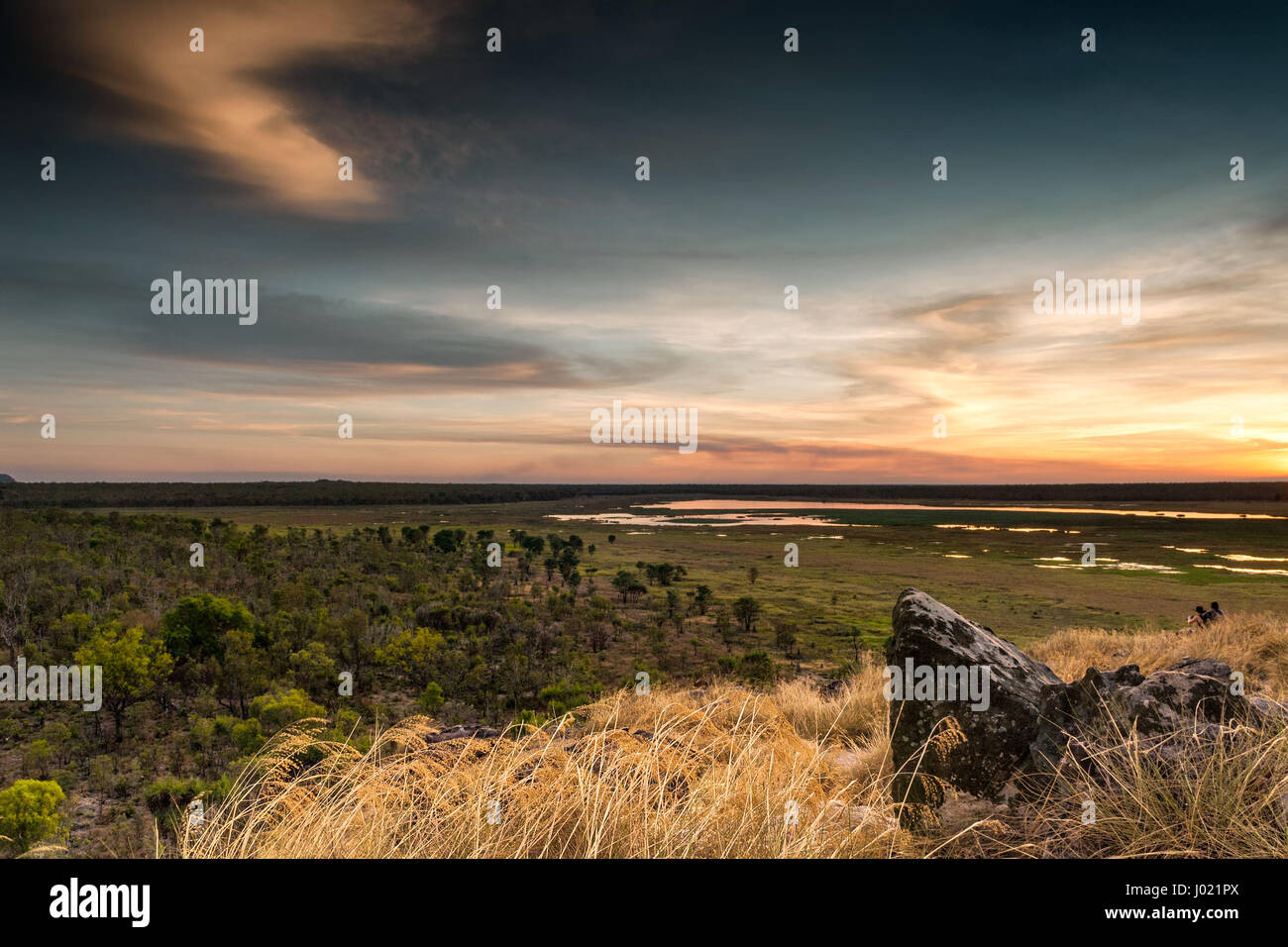 Dusk at Ubirr rock looking down at the sun reflected in the waters of the Nadab floodplains. Northern Territory, Australia Stock Photo