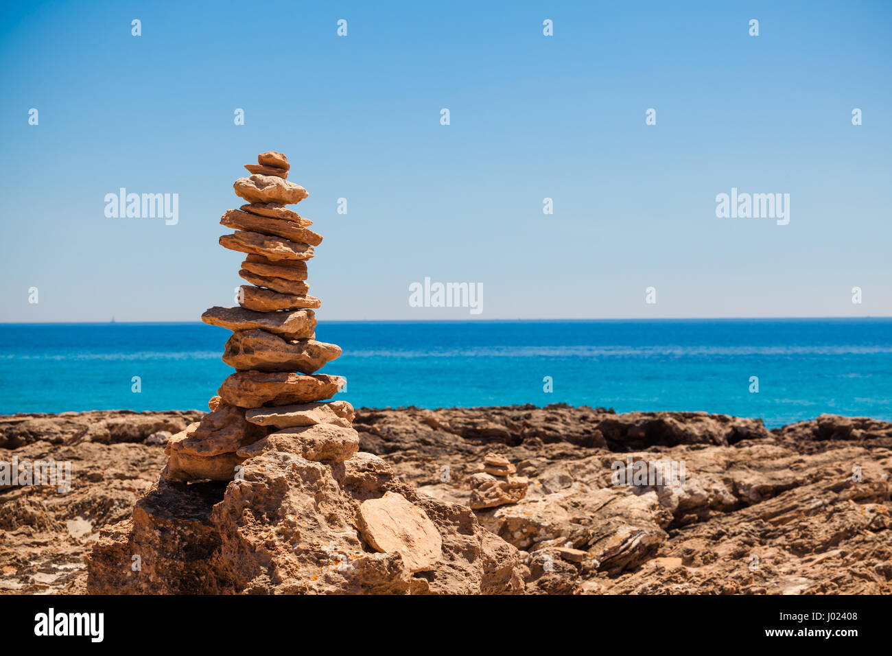 stack of stones on the beach and sea background Stock Photo - Alamy