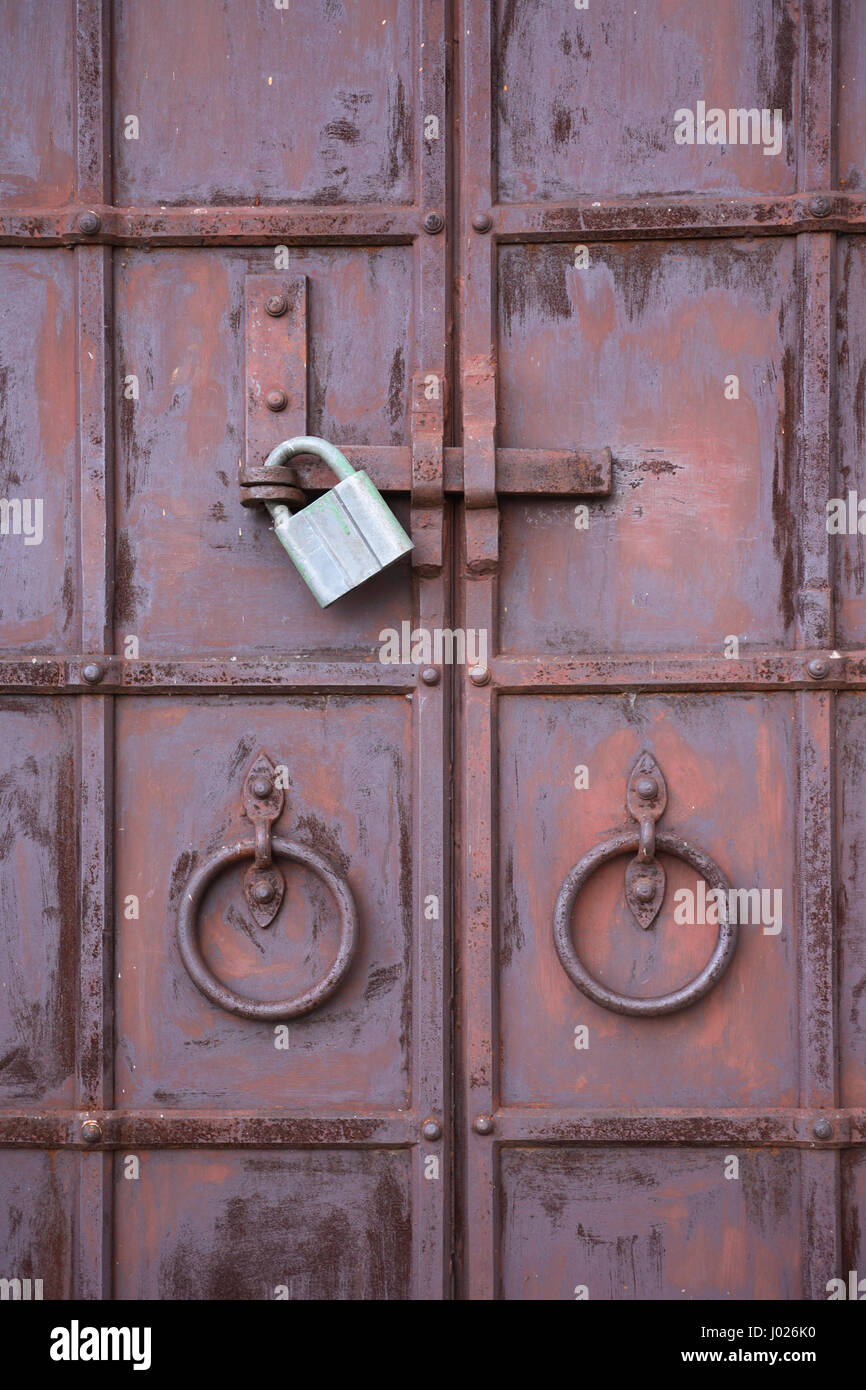 Closeup of old metal double door closed with lock Stock Photo - Alamy