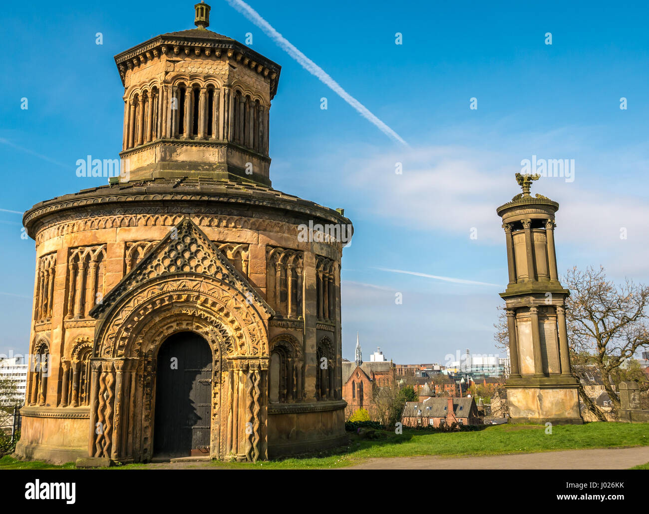 Elaborately carved round Victorian mausoleum, Necropolis hilltop overlooking Glasgow, Scotland, UK, with blue sky Stock Photo