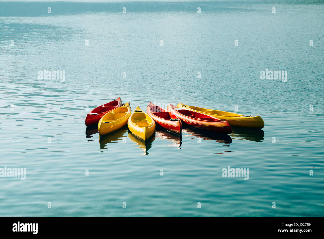 Kayaks moored in the water. Empty kayaks without people. In the Bay of Kotor,  in Montenegro Stock Photo - Alamy