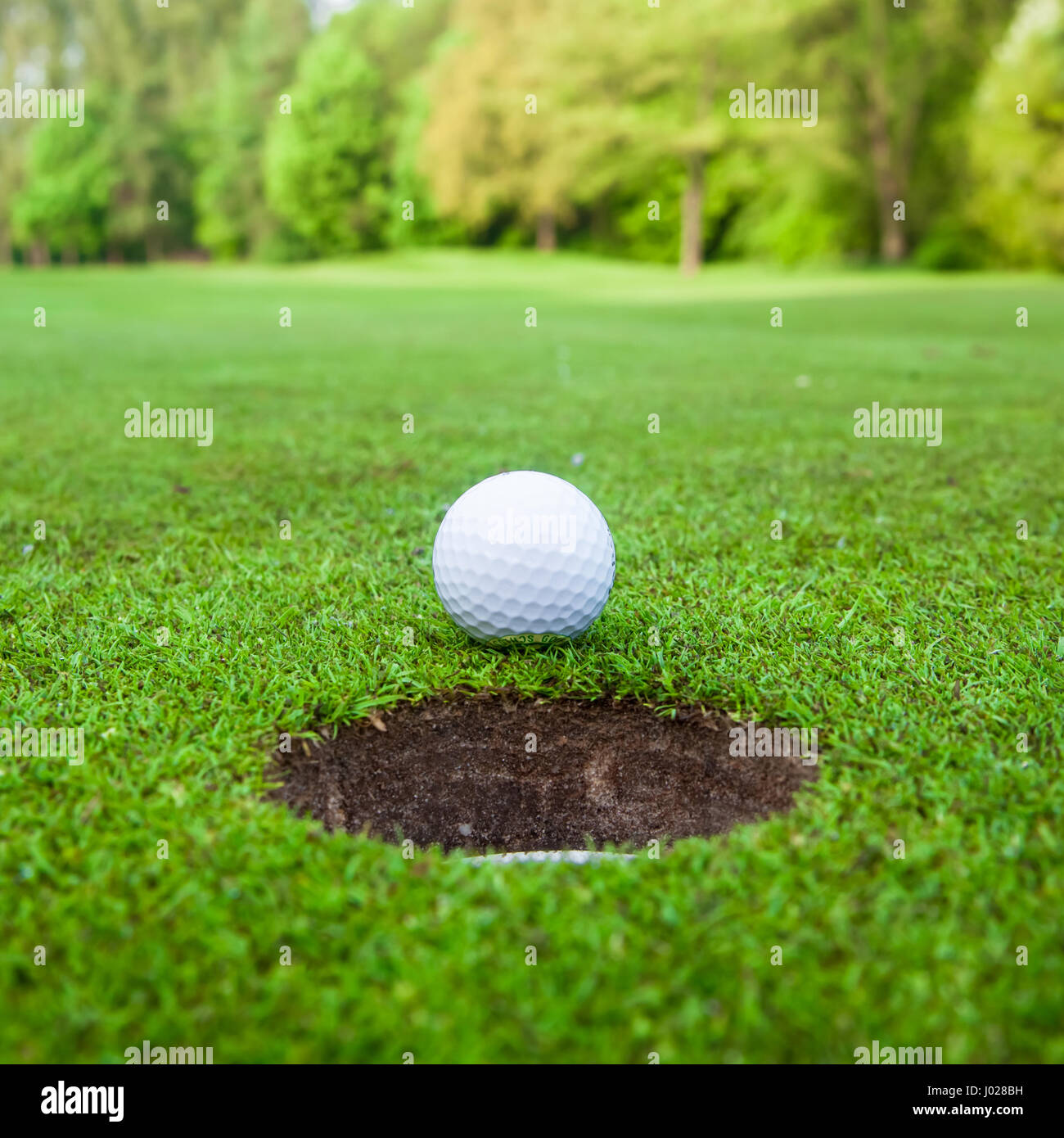 golf-ball-on-lip-of-cup-stock-photo-alamy