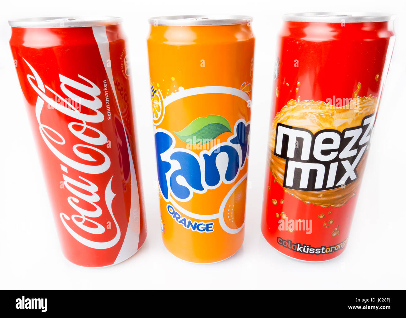 DUSSELDORF, GERMANY - March 28, 2014: Coca-Cola, Fanta and Mezzo Mix  cans on white background. The three drinks produced by the Coca-Cola Company are Stock Photo