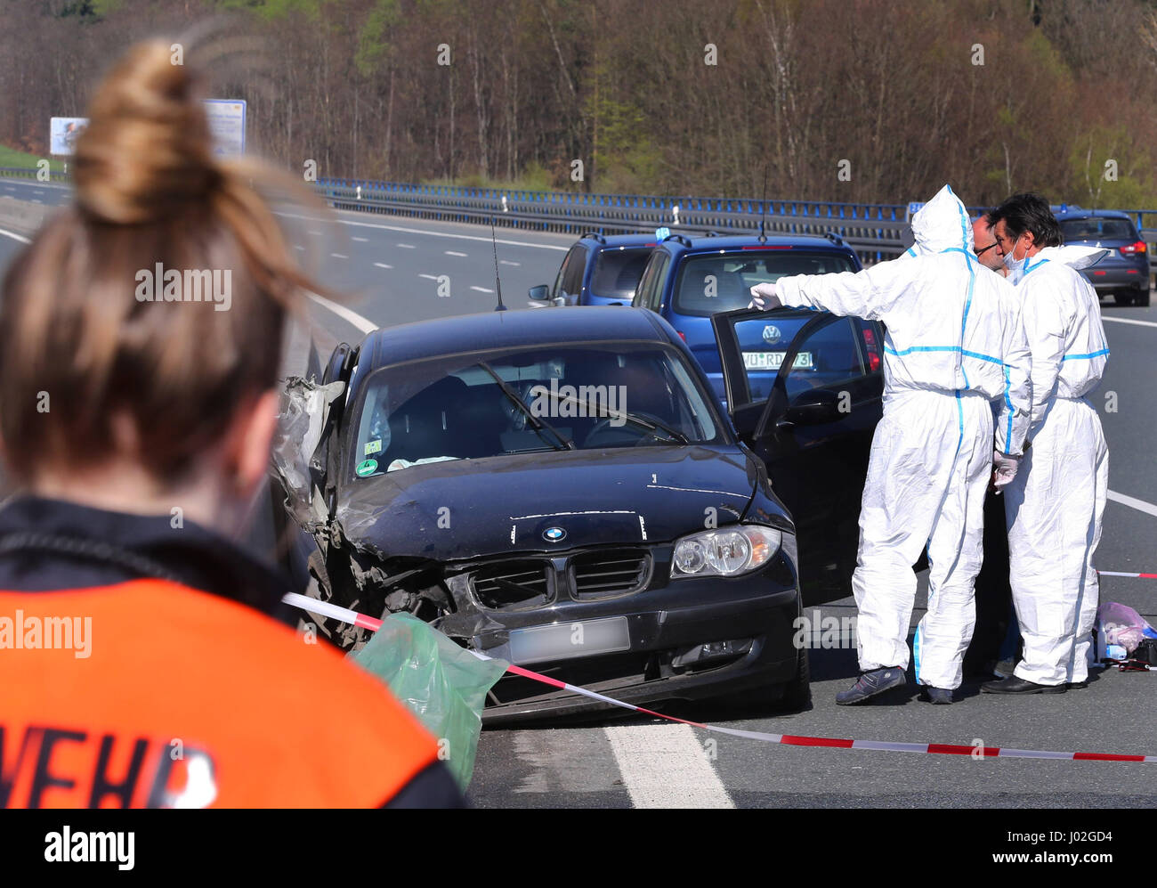 Bischbrunn, Germany. 09th Apr, 2017. Police investigators secure traces on car on the Haseltalbruecke bridge of the A3 highway at Bischbrunn, Germany, 09 April 2017. Inside the car the body of a woman was found, under the bridge a dead man. The police suspect a domestic relationship incident. Photo: Karl-Josef Hildenbrand/dpa/Alamy Live News Stock Photo