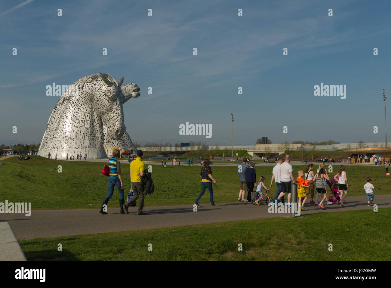 Falkirk, Scotland, United Kingdom. 8th April, Families enjoying spring sunshine flock to the Kelpies visitor attraction as the weekend heatwave hits Scotland. Credit: Alan Paterson/Alamy Live News Stock Photo