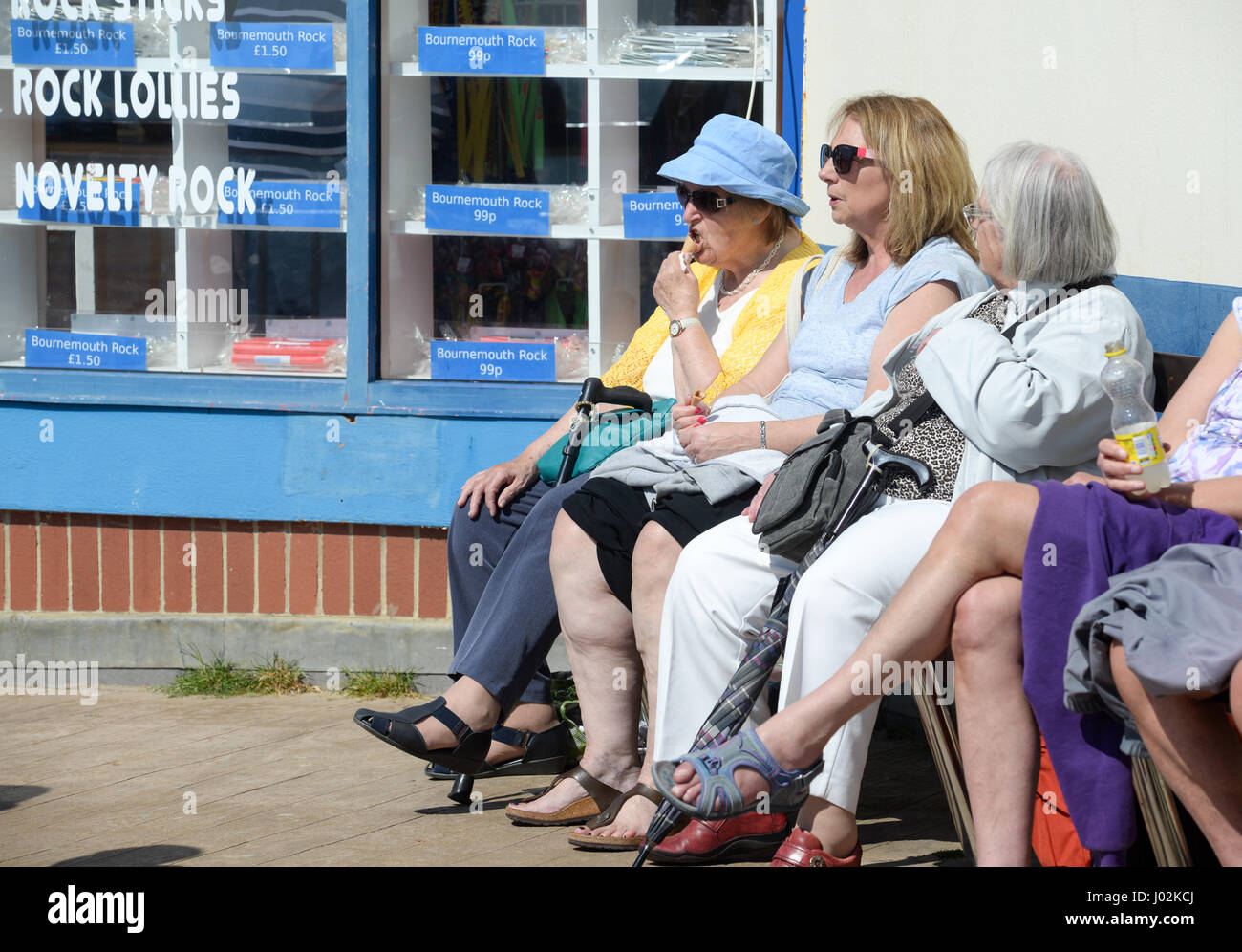 Senior people eating ice cream in hot sunshine Stock Photo