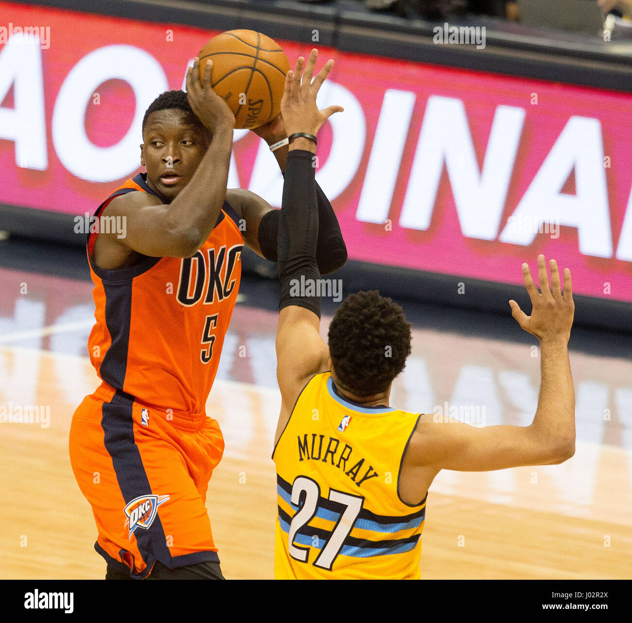 Denver, Colorado, USA. 9th Apr, 2017. Thunder's VICTOR OLADIPO, left, looks to pass the ball off with Nuggets JAMAL MURRAY, right, during the 1st. Half at the Pepsi Center Sunday afternoon. The Thunder beats the Nuggets 106-105. Credit: Hector Acevedo/ZUMA Wire/Alamy Live News Stock Photo
