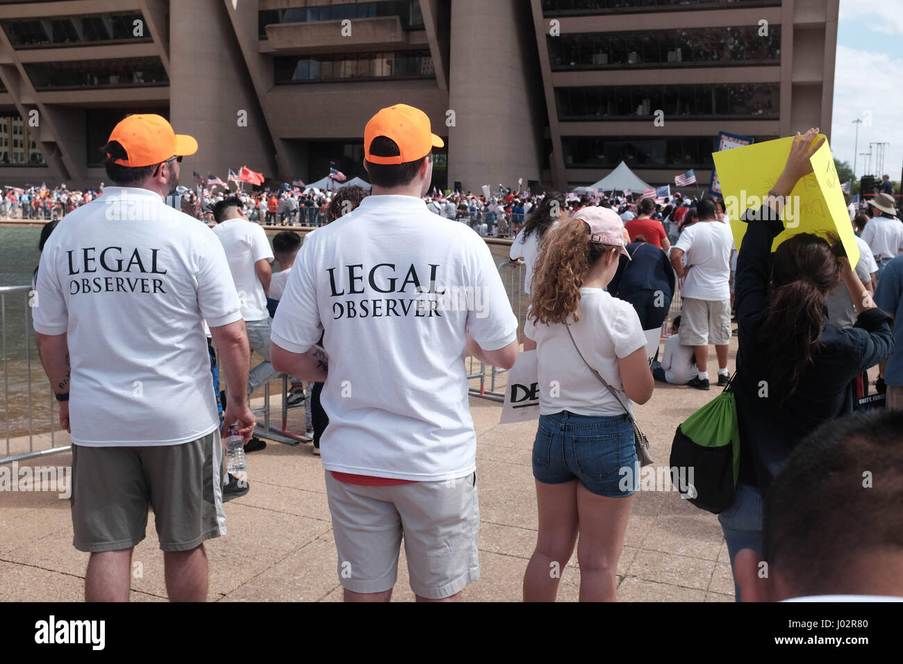 Dallas, Texas. 9th April, 2017. Thousands of  marchers rally at Dallas City Hall in support of imigration reform. Legal observers monitor in case disputes arise.  Keith Adamek/Alamy Live News Stock Photo