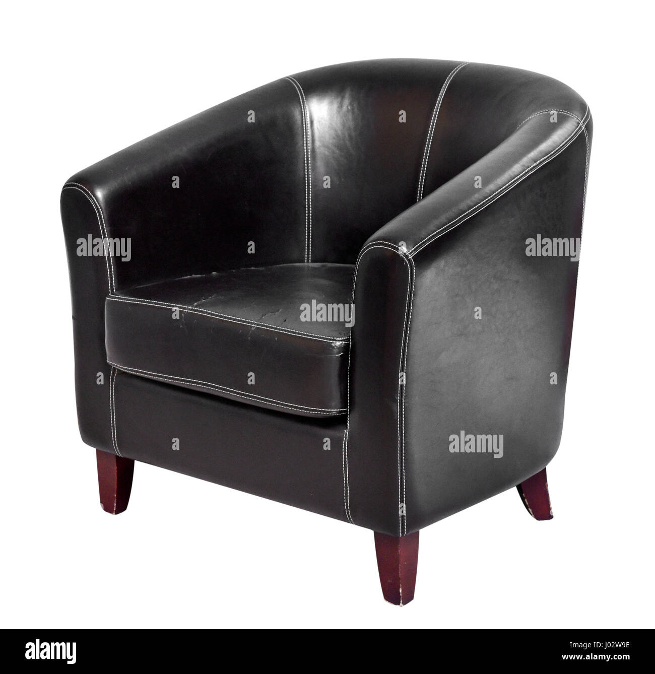 Black leather armchair with round back and short wooden legs isolated