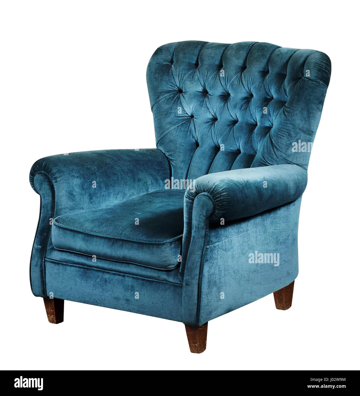 Blue velvet armchair with high back and short wooden legs, isolated on