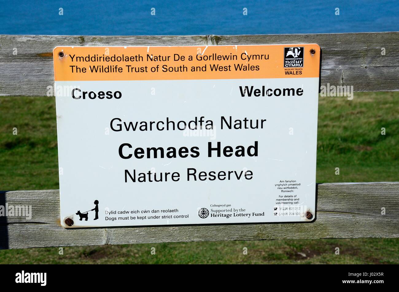 bilingual sign Welcom to Cemaes Head Nature Reserve Croeso i Gwarchodfa Natur Cemaes Head Wildlife Trust of South and West Wales Pembrokeshire Wales Stock Photo