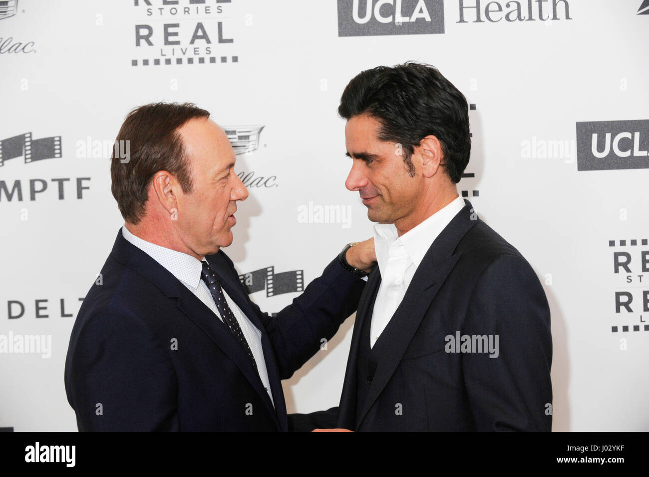 Honoree Kevin Spacey (L) and actor John Stamos attend the 4th Annual 'Reel Stories, Real Lives', benefiting the Motion Picture & Television Fund at Milk Studios on April 25, 2015 in Hollywood, California. Stock Photo