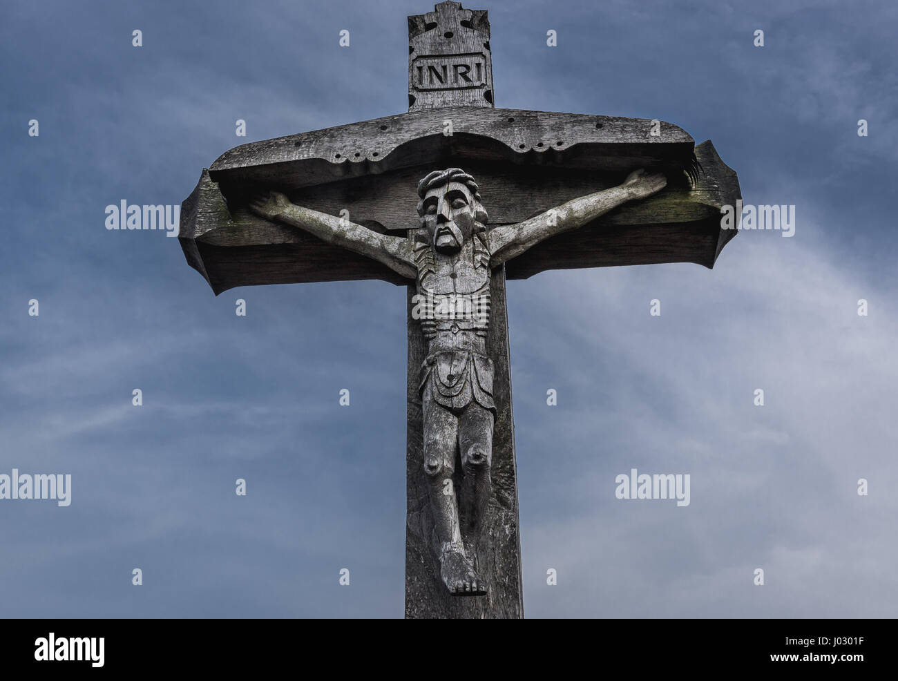 Wooden cross with Jesus figure on Hill of Crosses in Lithuania Stock Photo