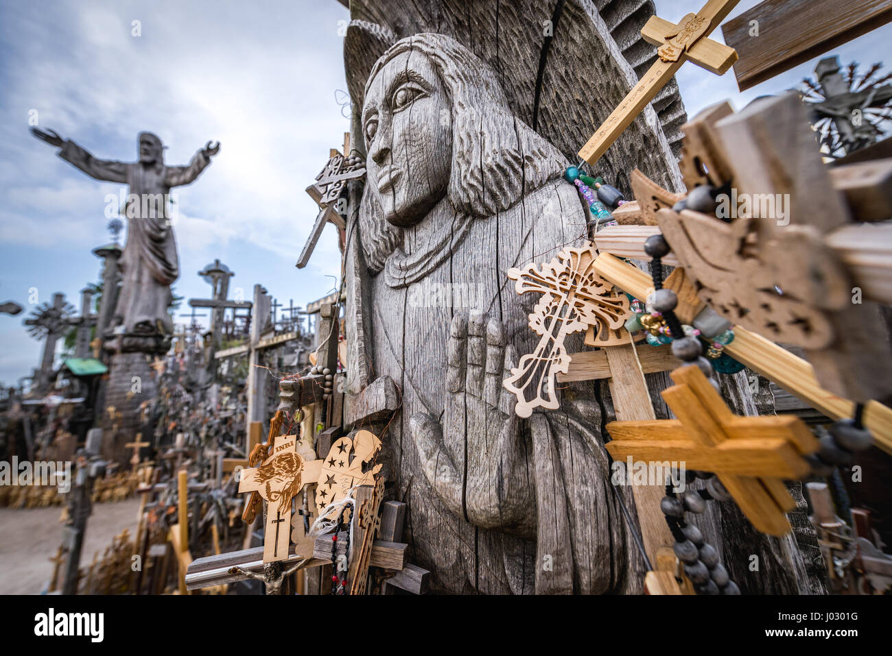 Wooden religious statues on Hill of Crosses in Lithuania Stock Photo