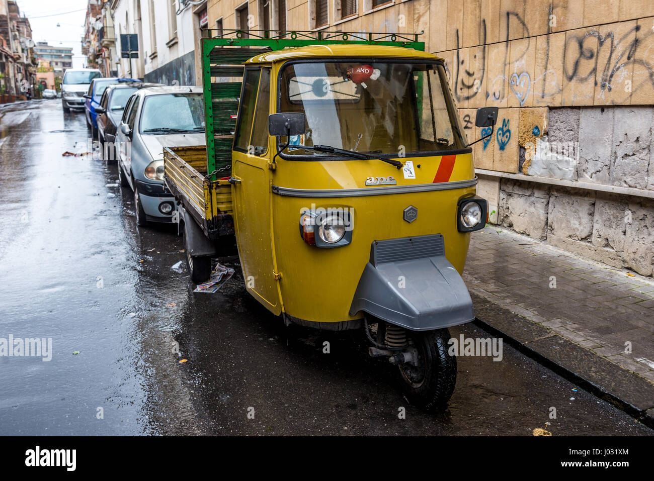 Piaggio Ape three-wheeled vehicle in Catania city on the east side of Sicily Island, Italy Stock Photo