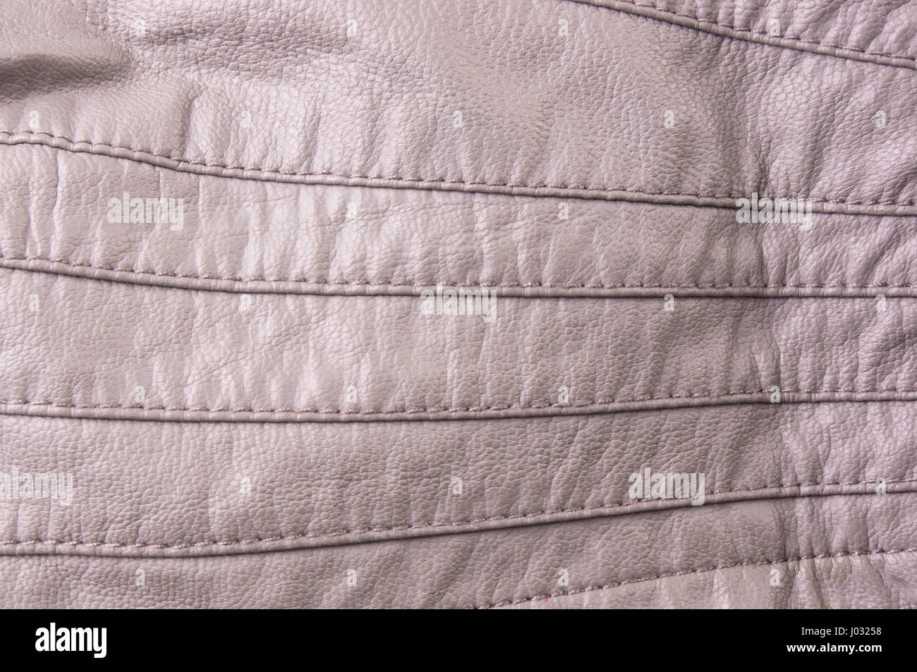 texture beige leather jacket with seams, close-up Stock Photo