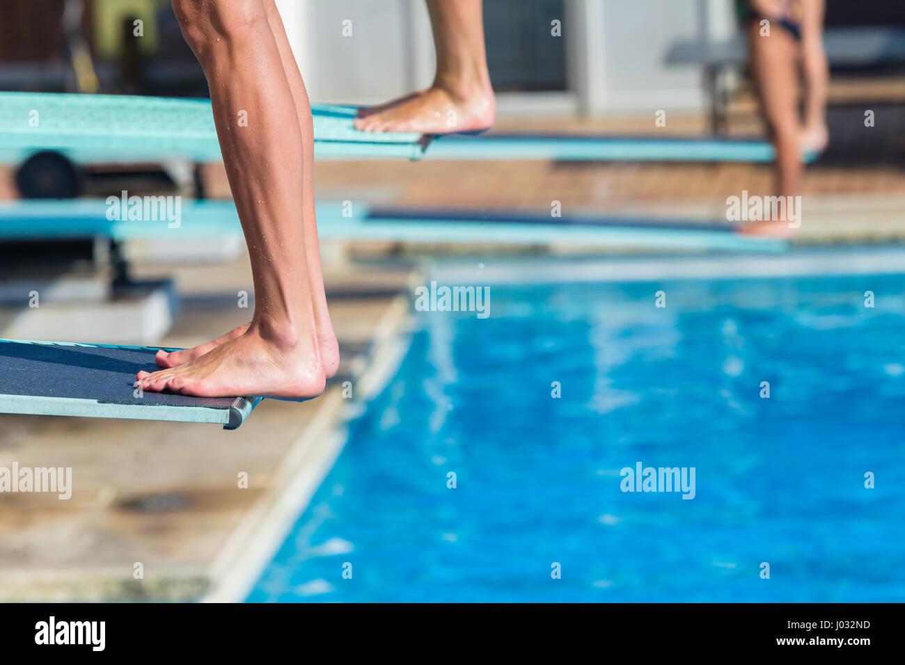 Aquatic diving pool divers feet edge of board for backflip into